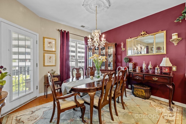 dining area with a chandelier and visible vents