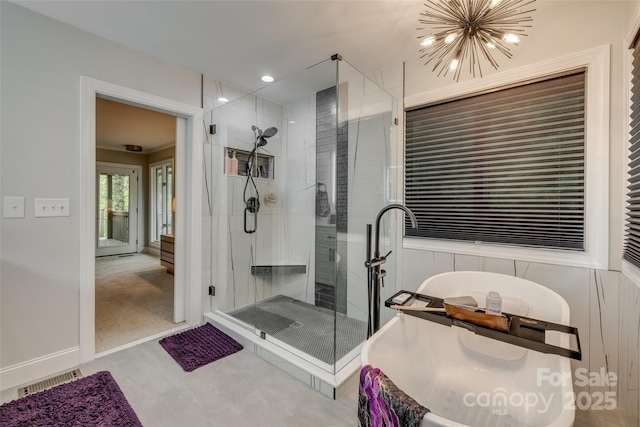 full bathroom with a freestanding bath, visible vents, an inviting chandelier, and a stall shower