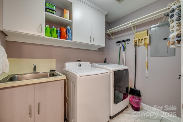 laundry area featuring electric panel, cabinet space, washer and dryer, marble finish floor, and a sink