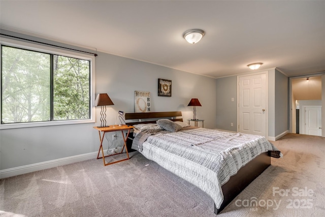 carpeted bedroom featuring baseboards