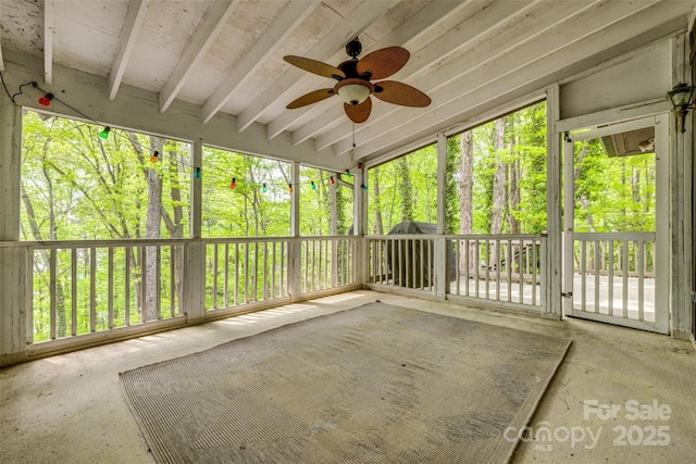 unfurnished sunroom featuring ceiling fan