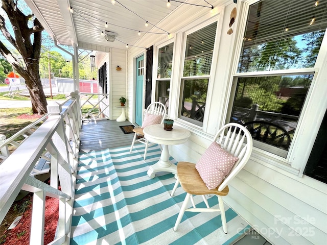 wooden terrace with a porch and ceiling fan