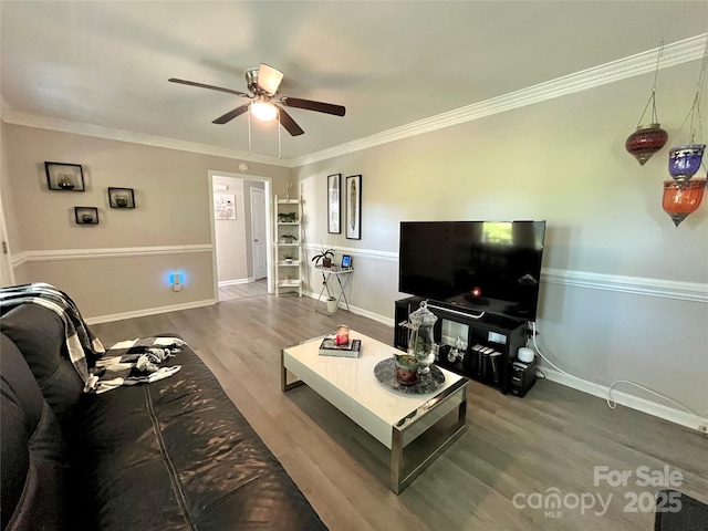 living room featuring wood finished floors, ornamental molding, baseboards, and ceiling fan