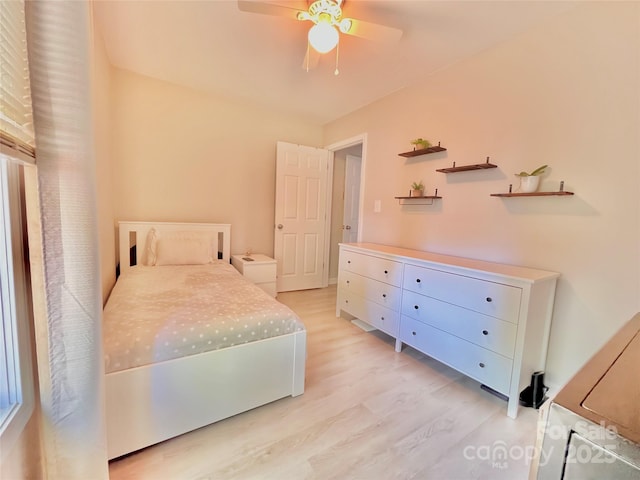 bedroom with light wood-style flooring and a ceiling fan