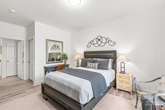 bedroom featuring light wood-style floors and baseboards
