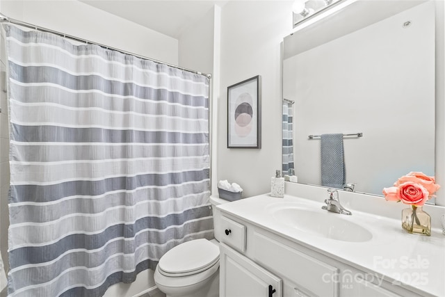 bathroom with toilet, vanity, and a shower with curtain