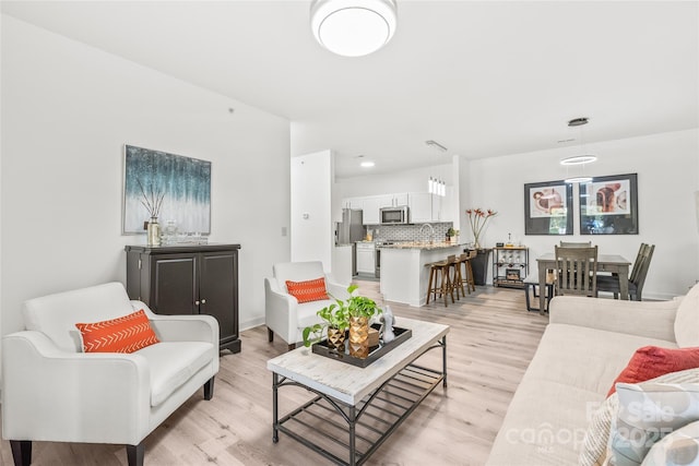 living room featuring light wood finished floors and recessed lighting