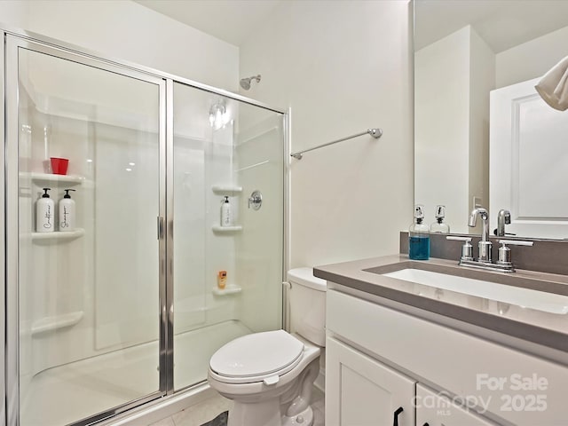 full bath featuring toilet, a stall shower, and vanity
