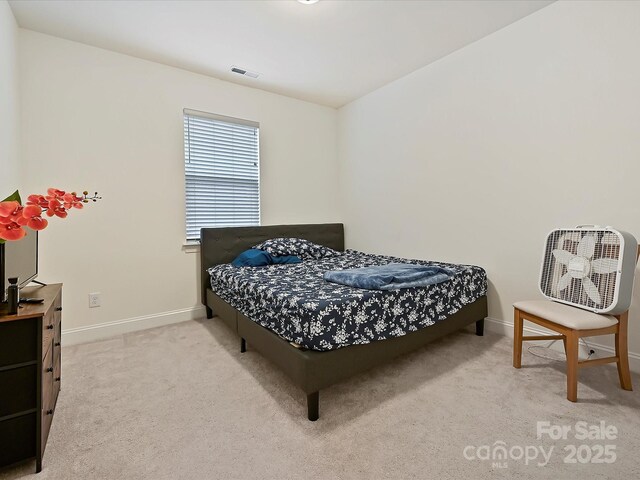 bedroom featuring carpet flooring, baseboards, and visible vents