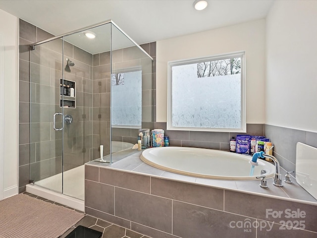 bathroom with a bath, recessed lighting, and a stall shower