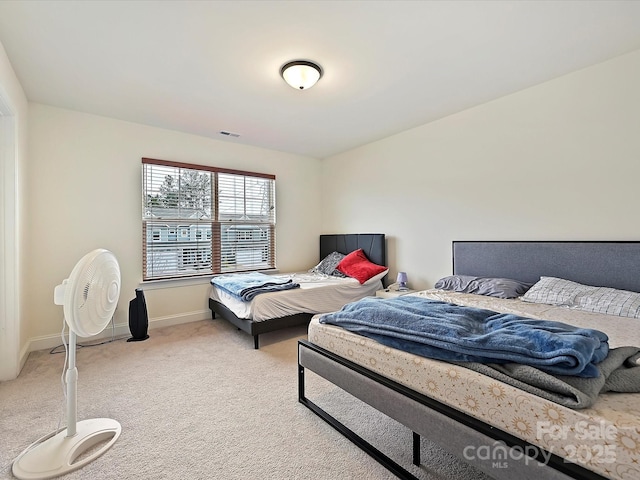 bedroom featuring light colored carpet, baseboards, and visible vents