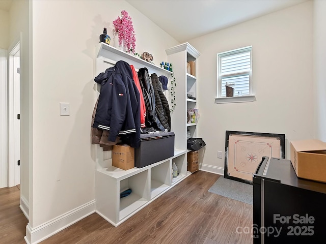 mudroom with baseboards and wood finished floors