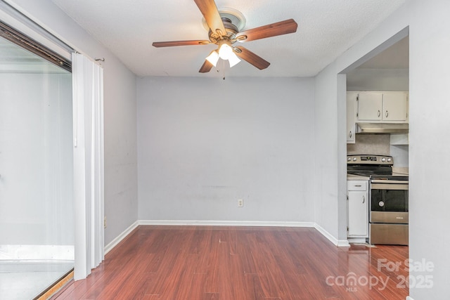interior space featuring ceiling fan, under cabinet range hood, white cabinetry, wood finished floors, and stainless steel electric range