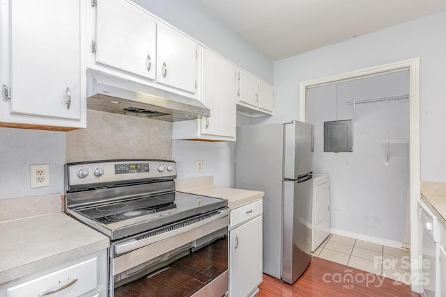 kitchen featuring washer / clothes dryer, white cabinets, light countertops, appliances with stainless steel finishes, and under cabinet range hood