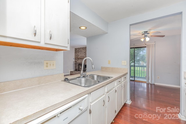 kitchen with light countertops, wood finished floors, a sink, and a ceiling fan