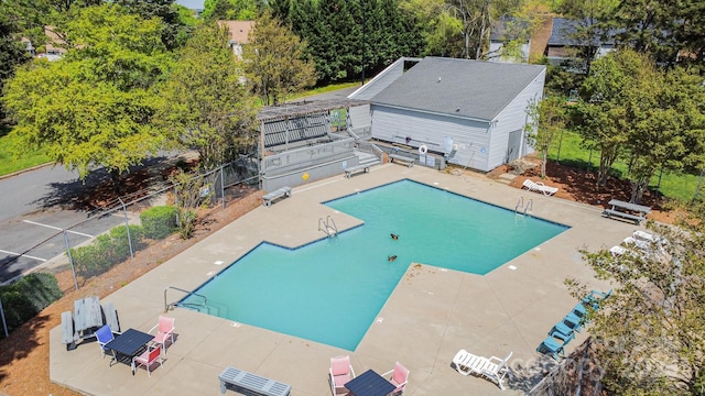 pool with fence and a patio