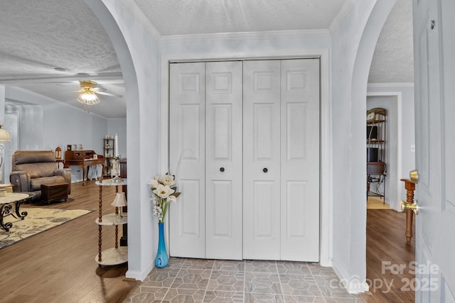 335 Ridgewood Dr, Mount Ulla, NC 28125 - foyer with ornamental molding, a ceiling fan, arched walkways, and wood finished floors