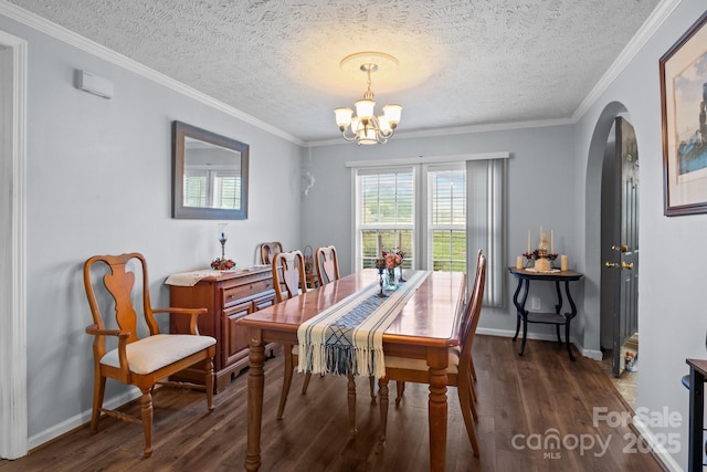 335 Ridgewood Dr, Mount Ulla, NC 28125 - dining area with a notable chandelier, baseboards, crown molding, arched walkways, and wood finished floors