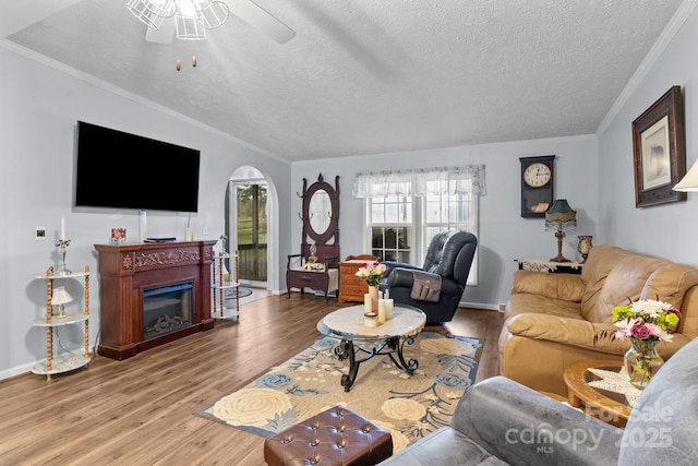 335 Ridgewood Dr, Mount Ulla, NC 28125 - living room with crown molding, ceiling fan, arched walkways, and wood finished floors