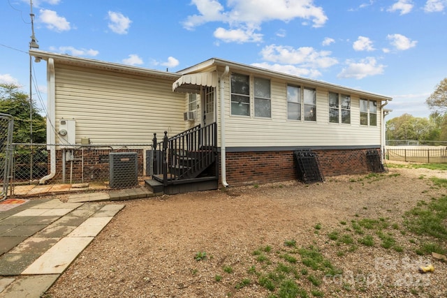 335 Ridgewood Dr, Mount Ulla, NC 28125 - back of property featuring entry steps, central air condition unit, cooling unit, and fence
