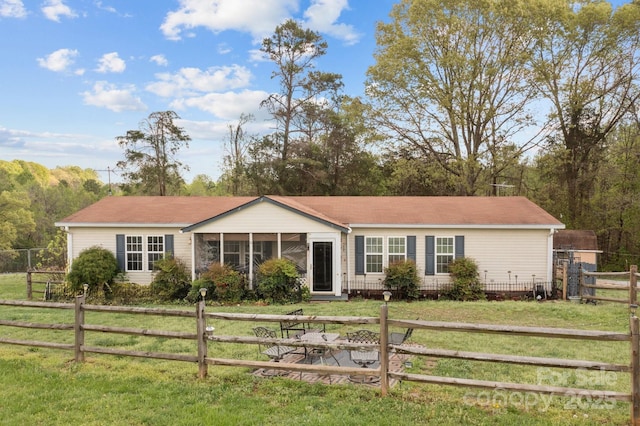 335 Ridgewood Dr, Mount Ulla, NC 28125 - ranch-style home featuring a front lawn, a sunroom, and a fenced front yard