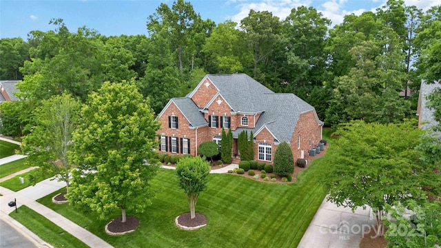 7302 Yellowhorn Trl, Waxhaw, NC 28173 - view of front facade featuring brick siding, a front lawn, and a shingled roof