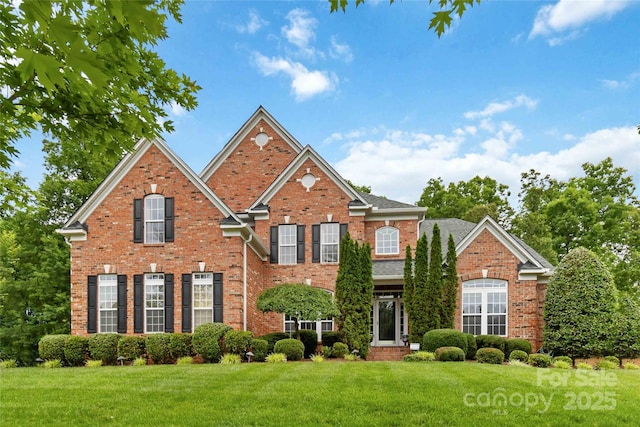 7302 Yellowhorn Trl, Waxhaw, NC 28173 - view of front of home with a front yard and brick siding