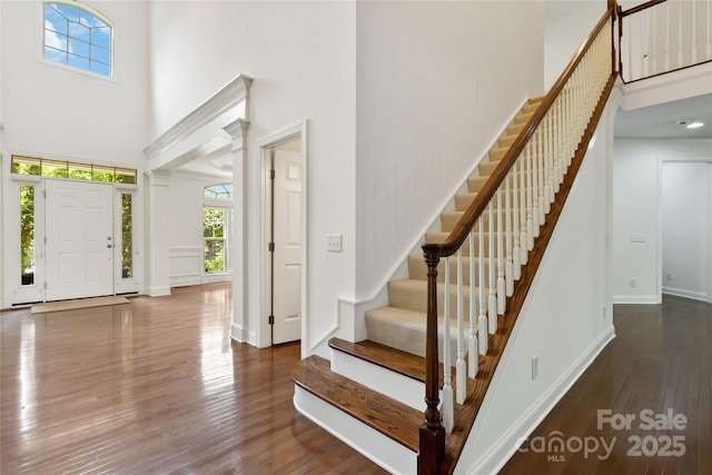 7302 Yellowhorn Trl, Waxhaw, NC 28173 - entryway featuring a towering ceiling, wood finished floors, stairs, and baseboards