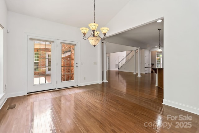 7302 Yellowhorn Trl, Waxhaw, NC 28173 - unfurnished dining area with stairs, hardwood / wood-style floors, a chandelier, and healthy amount of natural light