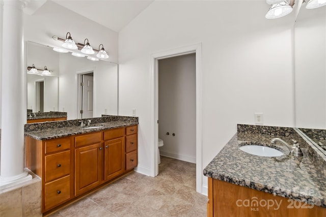 7302 Yellowhorn Trl, Waxhaw, NC 28173 - bathroom with ornate columns, two vanities, toilet, and tile patterned floors
