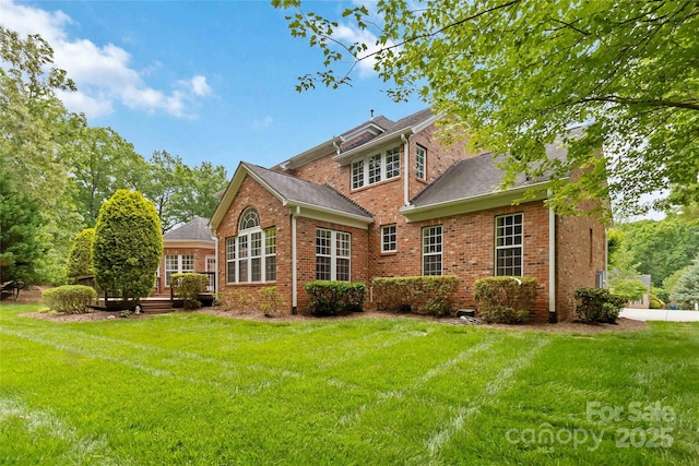 7302 Yellowhorn Trl, Waxhaw, NC 28173 - back of property with a yard, brick siding, a wooden deck, and roof with shingles