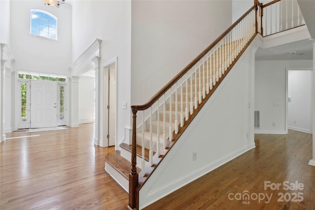 7302 Yellowhorn Trl, Waxhaw, NC 28173 - foyer featuring a towering ceiling, ornate columns, and healthy amount of natural light