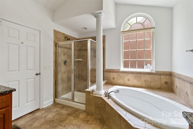 7302 Yellowhorn Trl, Waxhaw, NC 28173 - full bath featuring a bath, a shower stall, decorative columns, and vanity