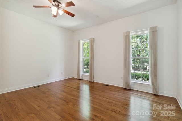 7302 Yellowhorn Trl, Waxhaw, NC 28173 - spare room with healthy amount of natural light, wood finished floors, and ceiling fan