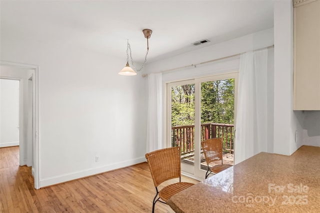 9 Canterbury Rd, Asheville, NC 28805 - dining room with light wood-type flooring, baseboards, and visible vents
