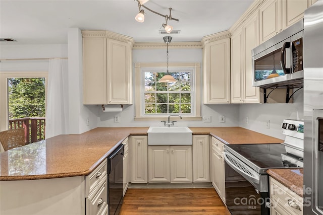 9 Canterbury Rd, Asheville, NC 28805 - kitchen featuring a peninsula, appliances with stainless steel finishes, wood finished floors, a sink, and cream cabinets