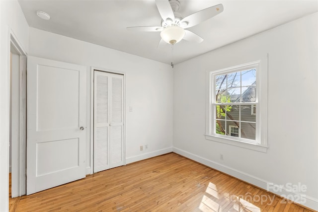 9 Canterbury Rd, Asheville, NC 28805 - unfurnished bedroom featuring a closet, baseboards, light wood-type flooring, and a ceiling fan