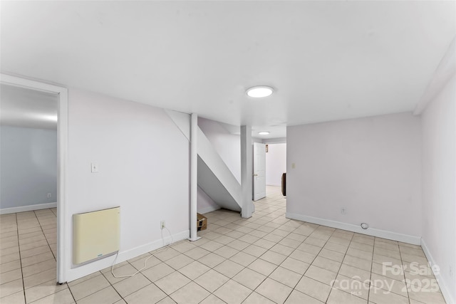 9 Canterbury Rd, Asheville, NC 28805 - finished basement with stairway, baseboards, heating unit, and light tile patterned flooring