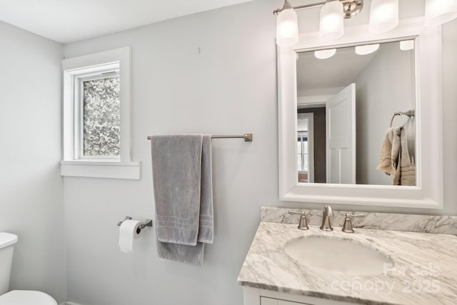 half bath featuring toilet and vanity