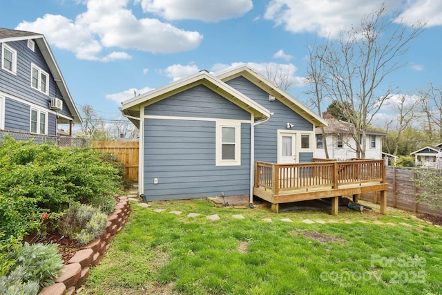 back of house featuring a yard, a fenced backyard, and a wooden deck