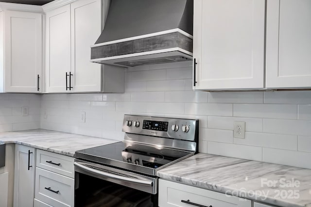 3612 Cobbleridge Dr, Charlotte, NC 28215 - kitchen with stainless steel range with electric stovetop, wall chimney exhaust hood, tasteful backsplash, and white cabinets