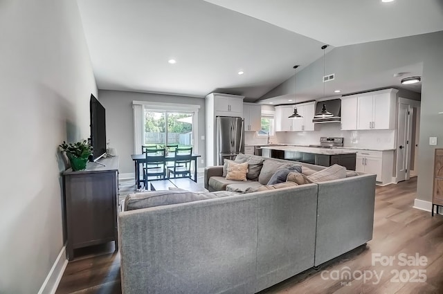 3612 Cobbleridge Dr, Charlotte, NC 28215 - living area with lofted ceiling, dark wood-style floors, baseboards, and recessed lighting