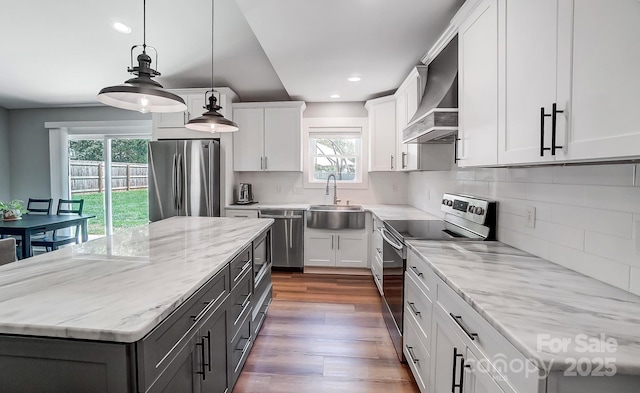 3612 Cobbleridge Dr, Charlotte, NC 28215 - kitchen with stainless steel appliances, wall chimney range hood, a sink, dark wood finished floors, and decorative backsplash