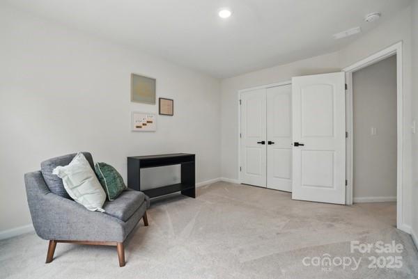 sitting room with light carpet and baseboards