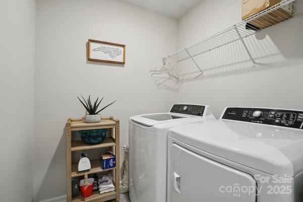 washroom featuring separate washer and dryer and laundry area