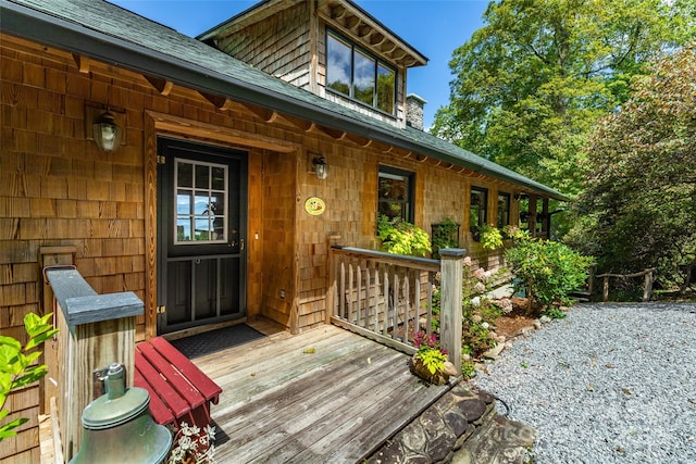 entrance to property with roof with shingles