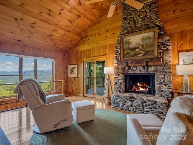 living room featuring wood walls, plenty of natural light, and wood finished floors