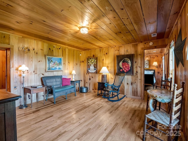 living area with wooden ceiling and wood finished floors