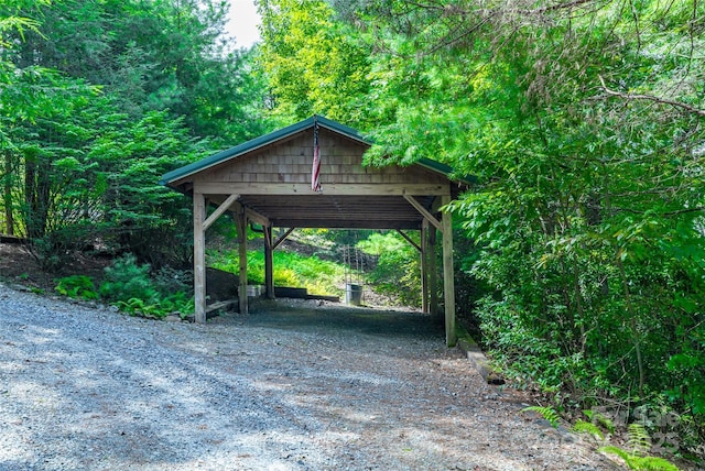 view of parking with a detached carport and dirt driveway