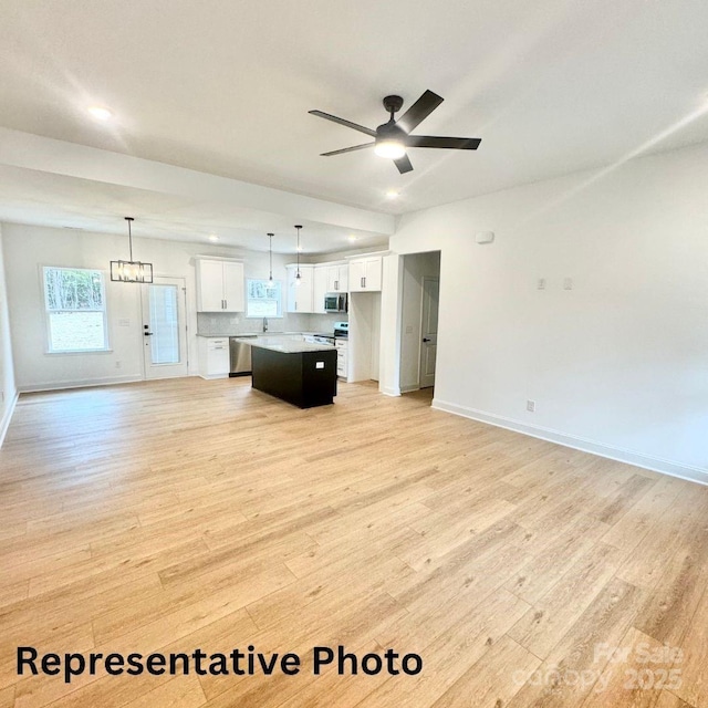 210 Carolina Drive 1000(&999), Troy, NC 27371 - living room featuring light wood-type flooring, baseboards, a ceiling fan, and recessed lighting